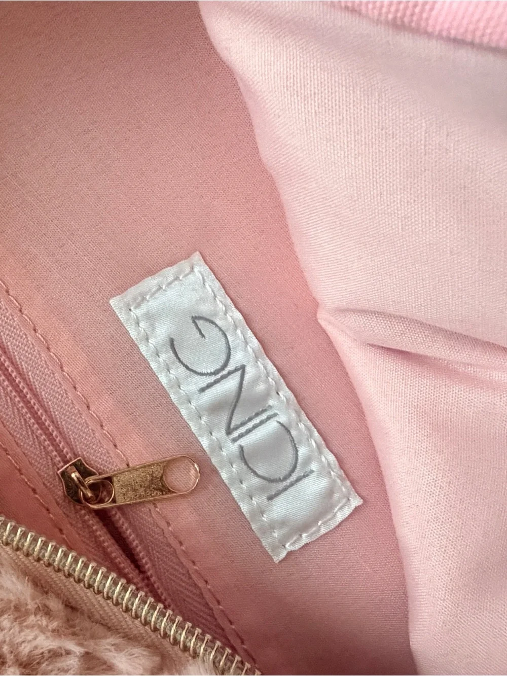 Two cute mini backpacks, one pink fuzzy, one white